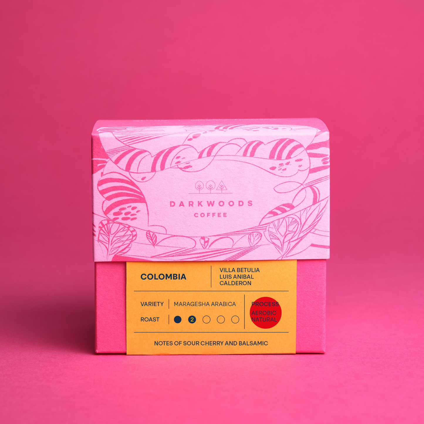 A packaged coffee product with iillustrated design on the upper half and a yellow label with text on the lower half, indicating the variety as 'Colombia Villa Betulia Ombligon' and the roast as 'Light'.